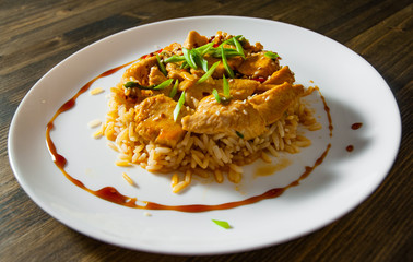 Chicken Breast with Rice in plate on a wooden background