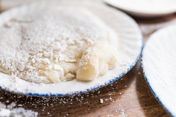 Piece of mochi sticky glutinous rice cake dusted with starch flour to make dessert