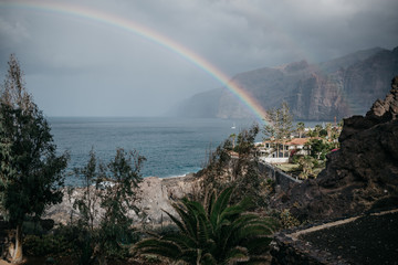 Rainbow under the harbor in the resort town Los Gigantes. Tenerife 