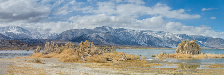 Panoramic view with mounds of the natural formation of tufa (calcium carbonate) at Mono Lake with the Sierra Nevada mountains in California, USA.