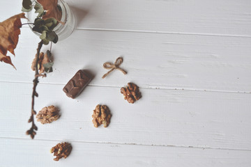 Chocolate candies, nuts and lavender on the white wooden table. Beautiful food flat lay.