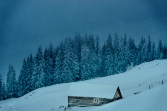 Wooden house in the winter in the mountains