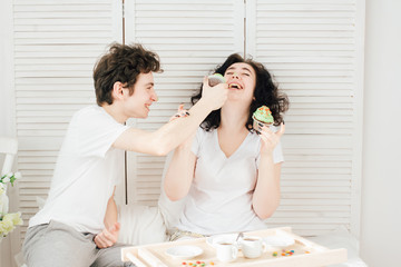 Loving couple dirty their nose with sweet cream