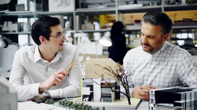 Two men working in design and engineering architecture office.