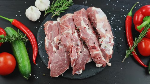 raw beef steak and salt with spices. modern composition delicious dish professional cooking master restaurant food fresh vegetables meat black chopping board red hot chilli pepper recipe ingredients