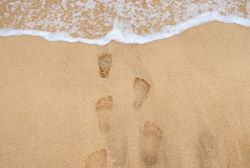 Footprints on the sand of the beach