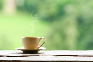 hot coffee with steam with green nature background