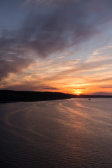Fototapeta na wymiar Sun sets over the horizon on the Volga River at Kama Mouth