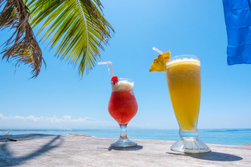 Two exotic cocktails on the table on tropical beach in Thailand