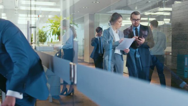 Business People Walking and Talking in the Hallway, Businessmen Have Conversation in the Office, Use Desktop Computer. Shot on RED EPIC-W 8K Helium Cinema Camera.