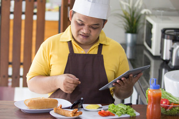 happy young man cooking his meal
