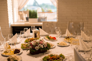 banquet hall of the restaurant, beautifully decorated tables with food