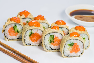 Japanese cuisine. Appetizing set of maki sushi rolls with rice, salmon, cucumber and sauce on light background