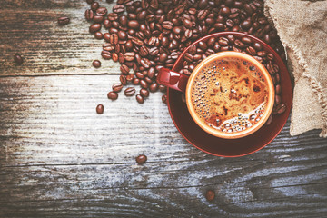 Coffee cup and coffee beans on table
