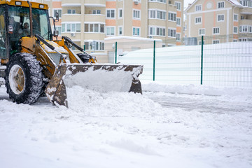 Clearing by the excavator of snow drifts