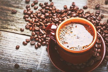 Coffee cup and coffee beans on table