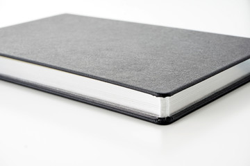 Image of black book diaries over white background