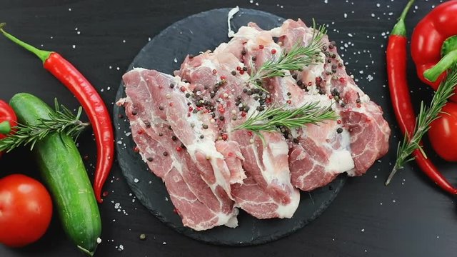 top view of fresh red meat and falling tree brench herb. red green vegetables garlic healthy lifestyle pepper herbs delicious restaurant cooking kitchen eco products hot spices beautiful composition