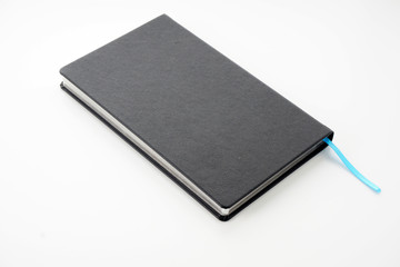 Image of black book diaries over white background