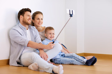 family taking selfie by smartphone at new home