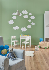 child room interior white carpet and grey sofa with cupboard decor.
