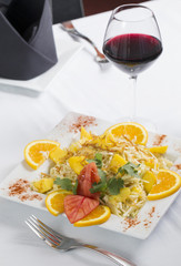 Mango Salad Indian food dish with fresh cut oranges plated with fork photographed from overhead above view