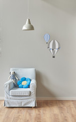 baby room decoration grey wall and grey lamp with armchair. parachute patterns.