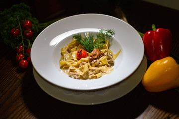 Pasta with tomatoes and parsley, surrounded by pepper