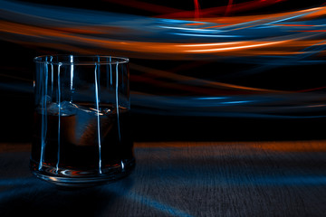 A glass of whiskey on the table. Bokeh effect.