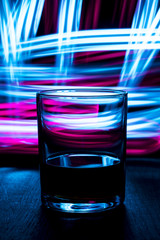 A glass of cognac in nightclub background.