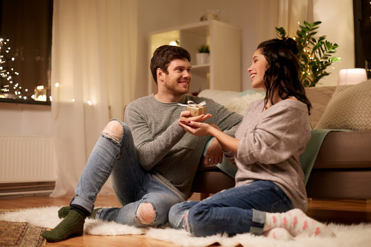 happy couple with gift box at home