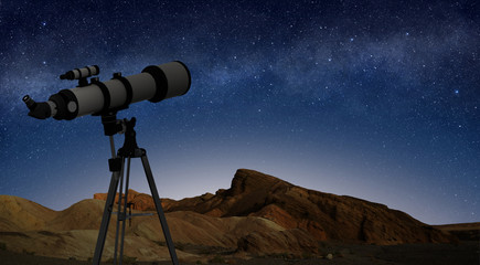 Fototapeta premium telescope on a tripod pointing at starry night sky