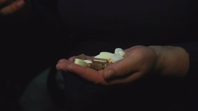 Woman taking pills. Slow motion video