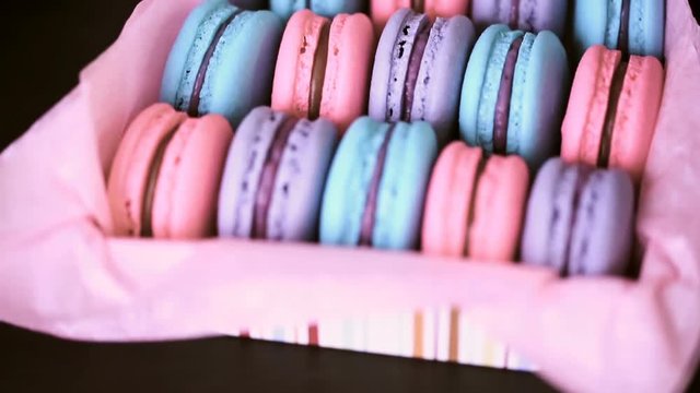 Row of colorful french macaroons in the box