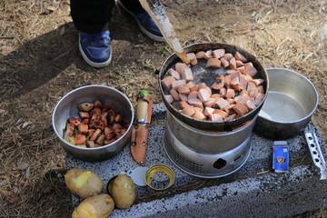 Outdoor cooking potatoes and sausage