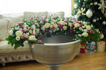 Bouquet flowers of roses in a huge steel vase. Shabby chic home decor.