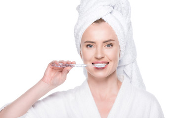 Woman with clean skin brushing teeth isolated on white