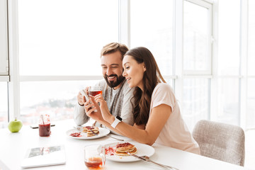 Happy young couple having breakfast