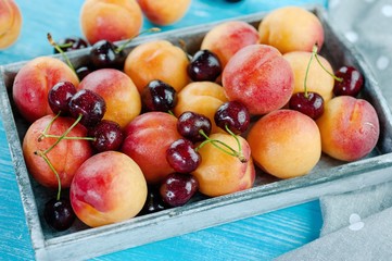 Peaches and cherries fresh fruit in a basket