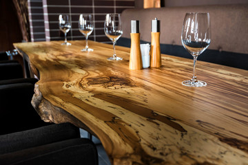 Empty wine glasses on slab table in restaurant