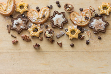 File types: All (27) Top view of a chocolate cookie in the form of stars and cookies in the form of a heart decorated with coffee beans, nuts and powdered sugar on a rustic wooden background. Copy tex