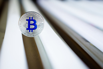 Cryptocurrency physical silver bitcoin  on on neon tubes in closed box