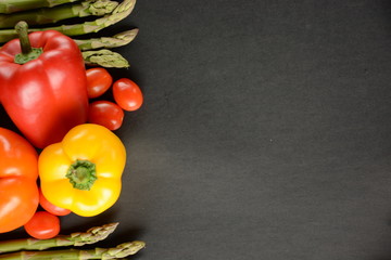 Fresh Colorful Vegetables ingredients for tasty vegan and healthy cooking  on black background, top view, frame. 