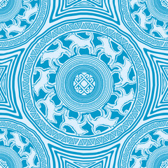 seamless texture with mandalas in primitive, ethnic style rock cave figure with animal ornament of the wolves and a solar sign in the center (blue and white colors)