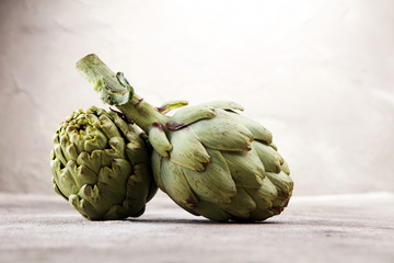 Obraz premium artichokes on grey background. fresh organic artichoke flower.