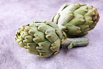 artichokes on grey background. fresh organic artichoke flower.