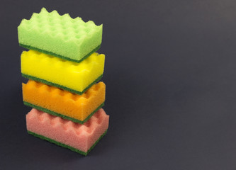.multicolored sponges for washing on a blue background