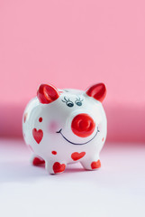 Savings concept. Funny piggy bank and on pink background