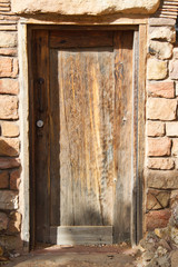 A wood door on a historic southwest style building with copy space.