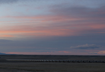 train on the prairie at sunset